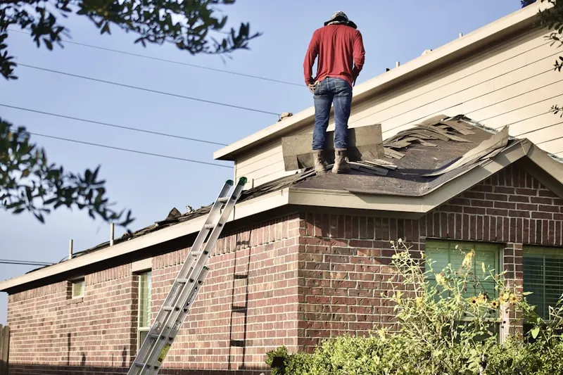 Professional roofer working on a residential roof in Connersville